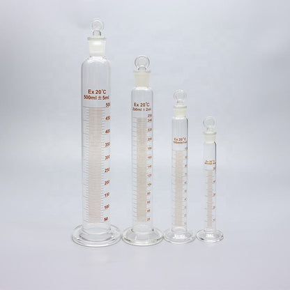 Single thick-walled Boro 3.3 glass graduated measuring cylinder with spout and graduation; matches title